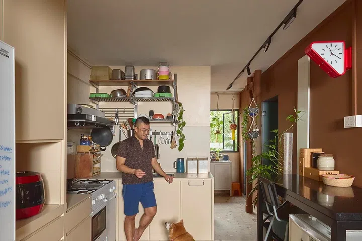 Spot the red triangle-shaped clock on the wall in his and his partner’s kitchen