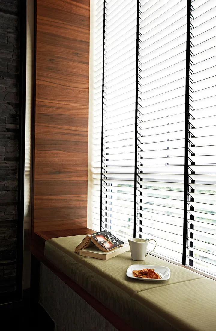 Cushions turn the bay window in the living room into a comfortable perch. Interior design by Metaphor Studio