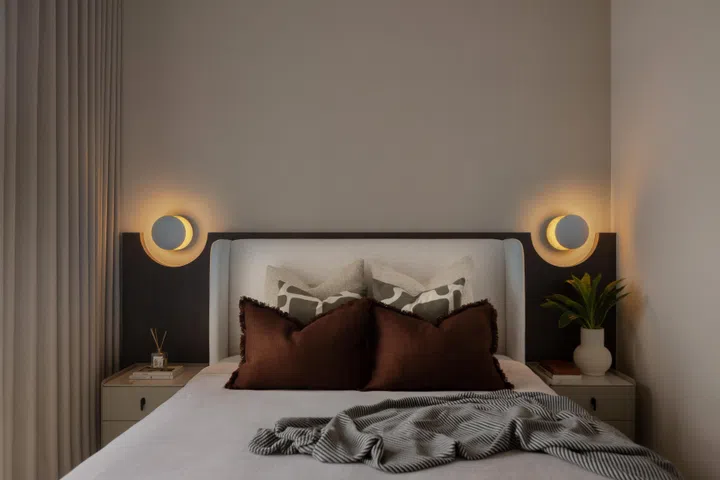 The master bedroom’s bed headboard came with cutouts to accommodate a pair of bedside wall lamps.