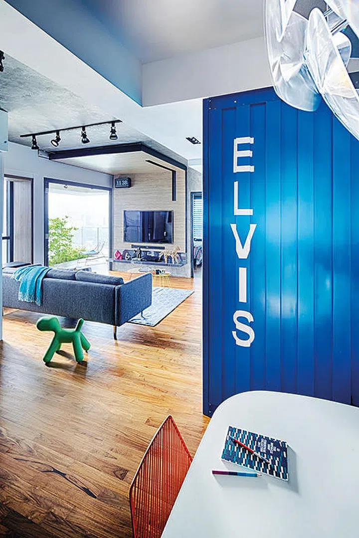 The wood-clad canopy and flooring bring warmth to the industrial-style apartment.