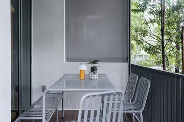 Homeowner Nicholas’ outdoor balcony in central Singapore with a 10-seater dining table.