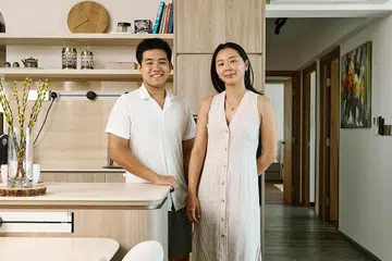 30s Couple lawyer Joshua and marketing director Li Yin poses for a photo in their newly-renovated 5-room resale HDB in Bukit Batok.