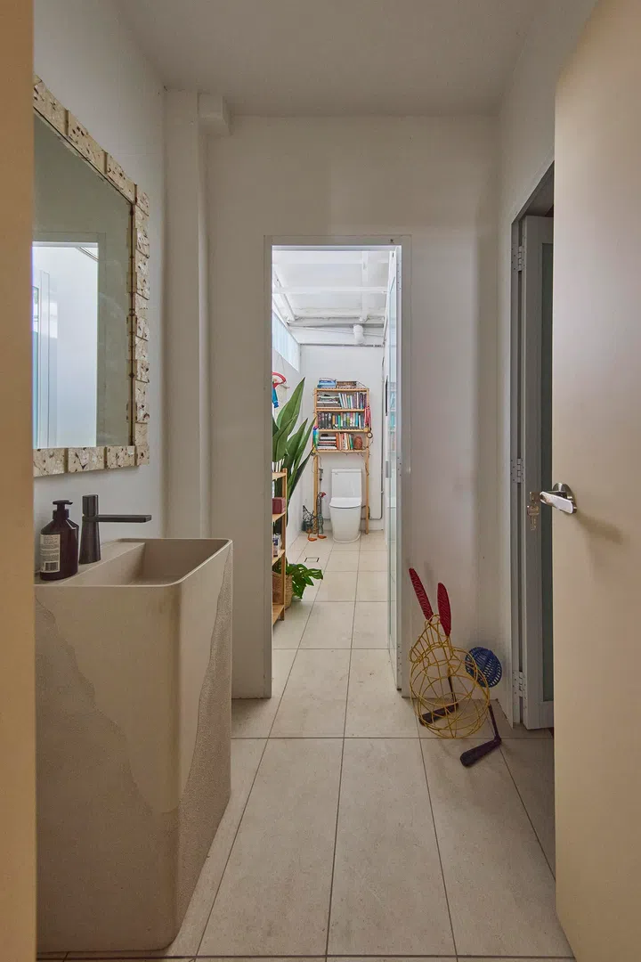 A textured basin and framed mirror add character to the common bathroom.The common bathroom adopts a lighter palette, maintaining material consistency in a more understated form.
