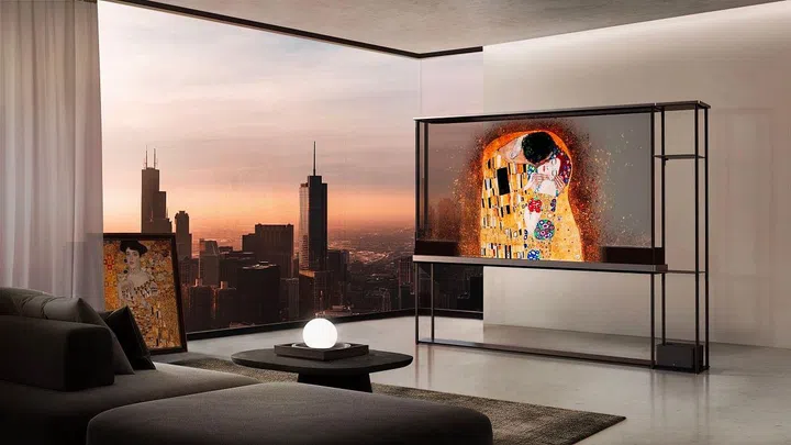 The transparent LG Signature OLED T TV set on black frames in a high rise penthouse living room. Photo LG