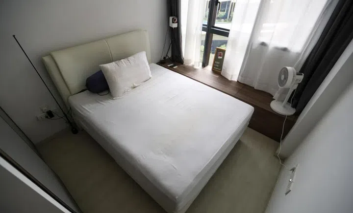 Mr Jon Phua’s bedroom includes a bedside ledge which functions as a table and storage space.