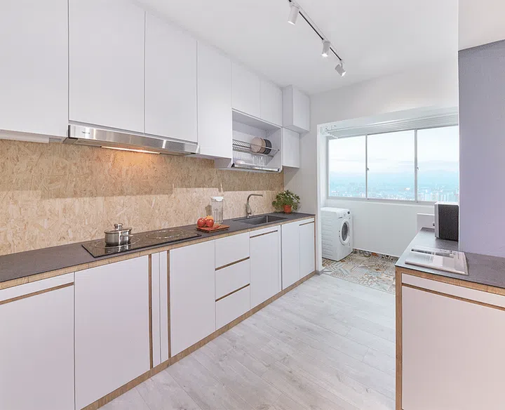 Though the homeowners decided to combine kitchen and yard space, they've maintained a demarcation between two spaces by using printed tiles in the latter. Interior design by Ju Design Studio.