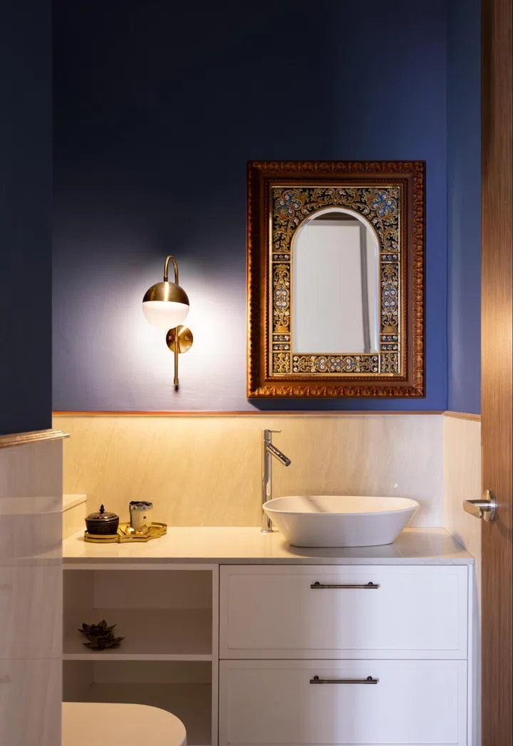 The bold wall complements the ornate ceramic mirror in a 3-bedroom condo in Orchard Scotts.