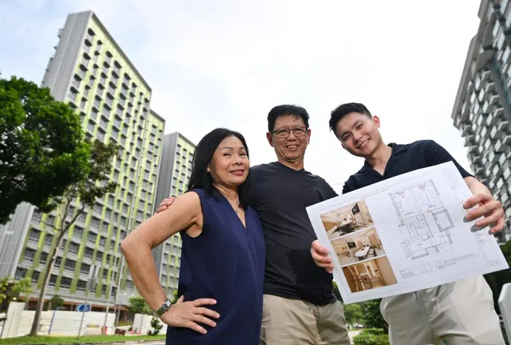 (From left) Angie Lam and her husband Philip Yeoh with their interior designer Benjamin Toh in front of their BTO flat in Kovan. The couple collected the keys on July 20, 2026, and it will take about three months to renovate the home.