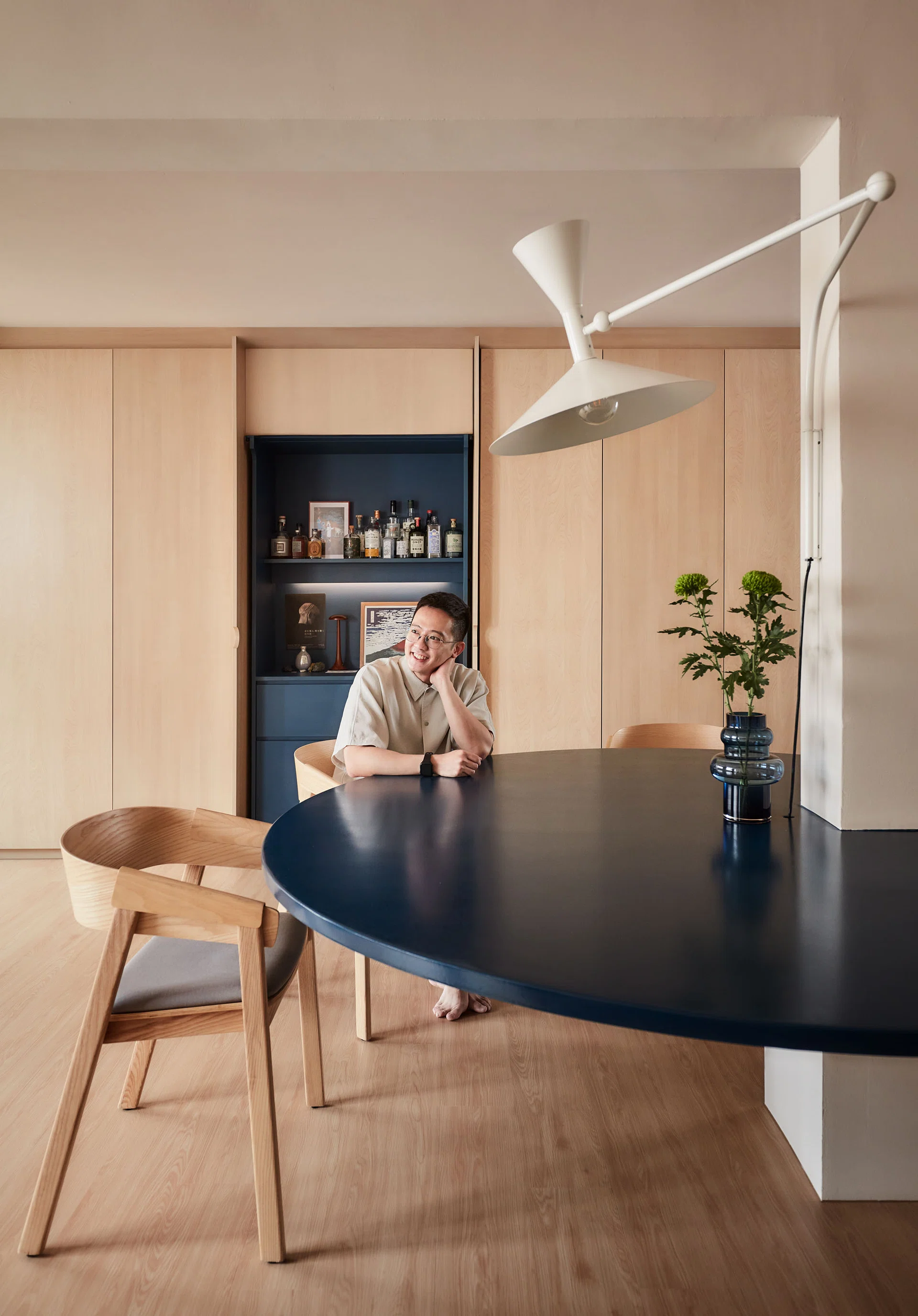 Mounted on the column and hovering above the table is a Le Corbusier Lampe de Marseille wall lamp.