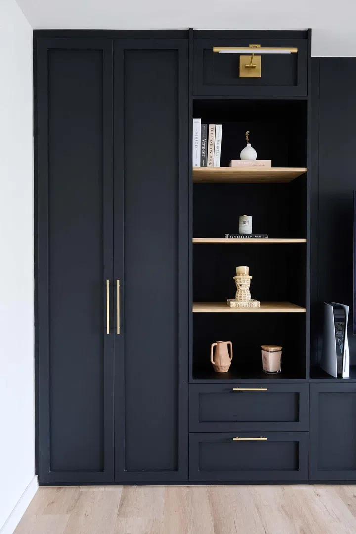 Black open shelves because they are well-suited for displaying decorative items in this 32-year-old man's 5-room HDB in Tampines Ave 8.