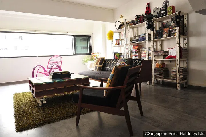 The living room is jazzed up with a furry rug as well as interesting, colourful accessories.