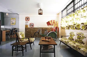 Against a concrete wall and road signs, this little vignette looks just like a snapshot of 60s Singapore.