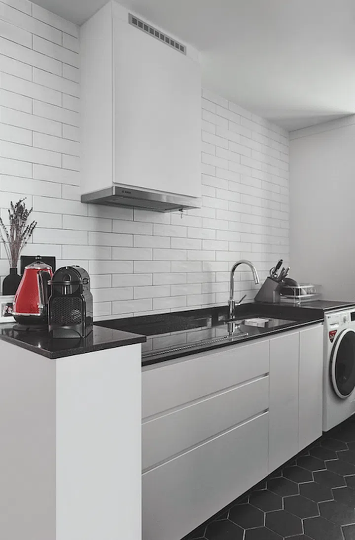 To brighten the compact galley-style kitchen, they opted for a mostly white palette.