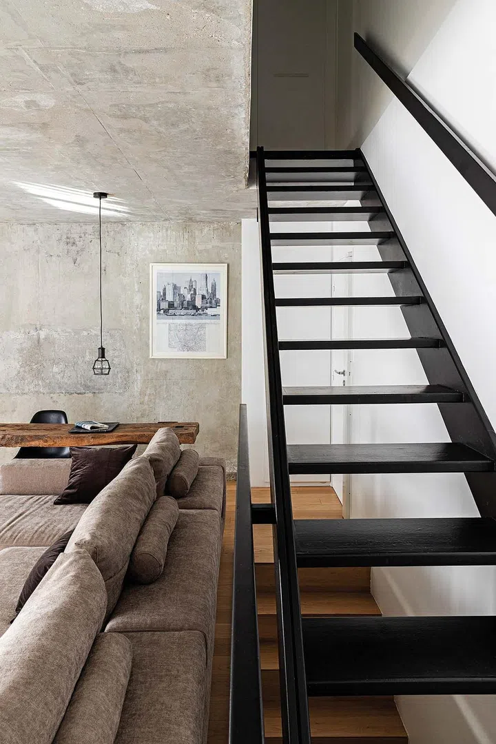 The main entrance opens onto the main living area, with stairs leading up to the terrace and down to the bedrooms.