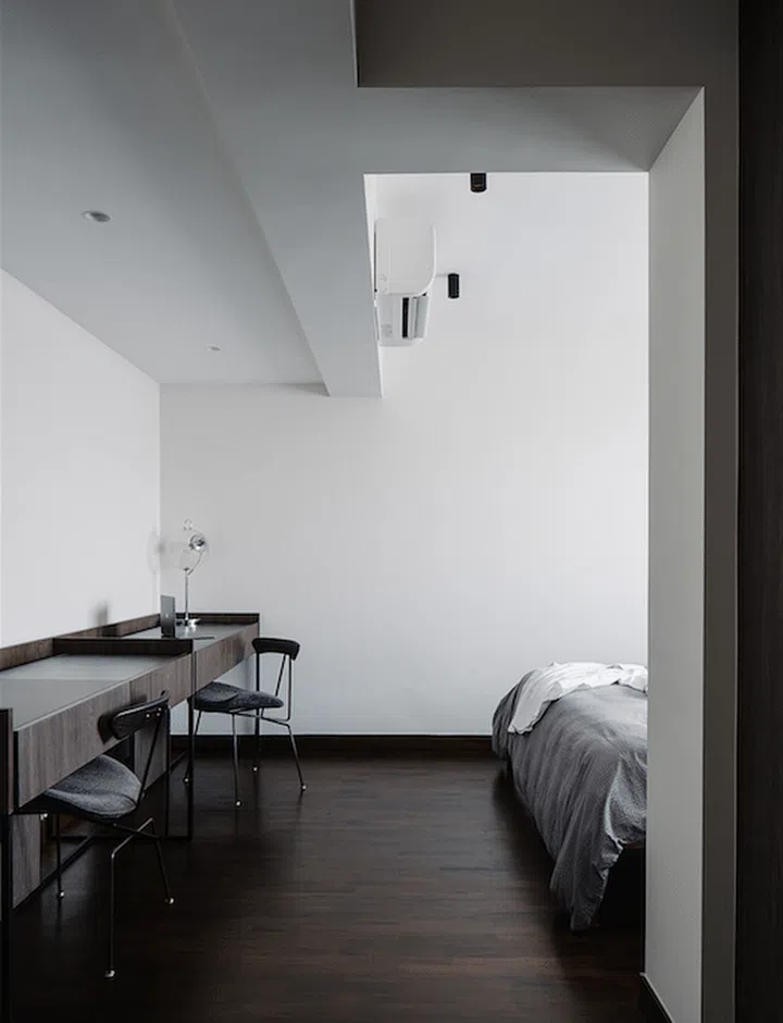 A study desk from Vietnam-based British design team Square Roots doubles as a dressing table. The Lamb chairs feature black steel frames with slate fabrics and raw oak backs. Interior design by TLD. Design.