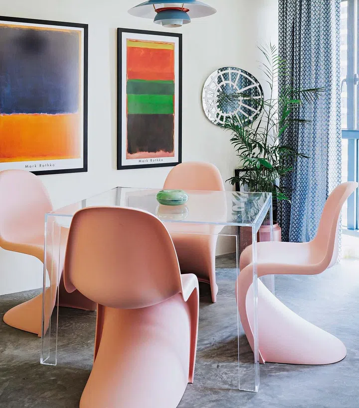 The Invisible table from Kartell complements the Vitra pink Panton chairs and creates a sense of space in the dining area.