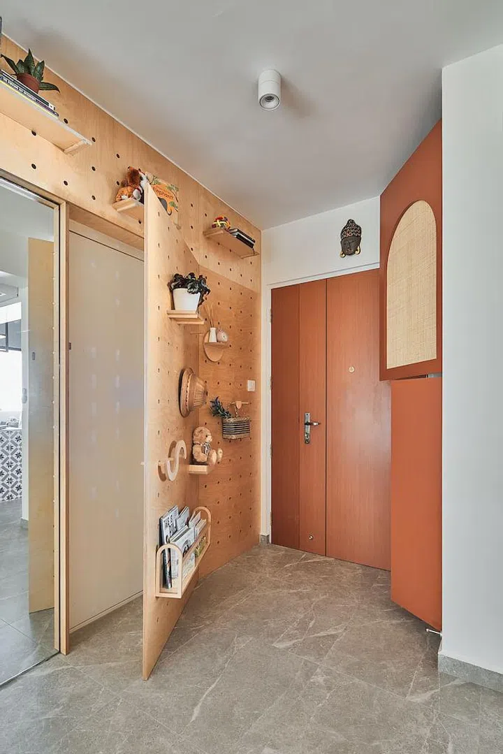 To conceal the household bomb shelter, the team fitted a pegboard wall next to the front door.