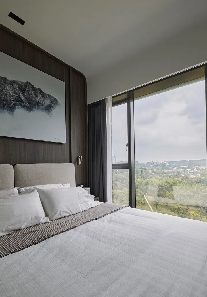 A light-filled sanctuary framed by floor-to-ceiling windows, where restful tones and soft textiles create a calming retreat above the treetops.