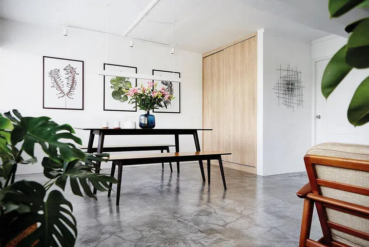 A matching set of minimalist black dining table and dining bench in an apartment in Singapore. Interior design by Studio JP.