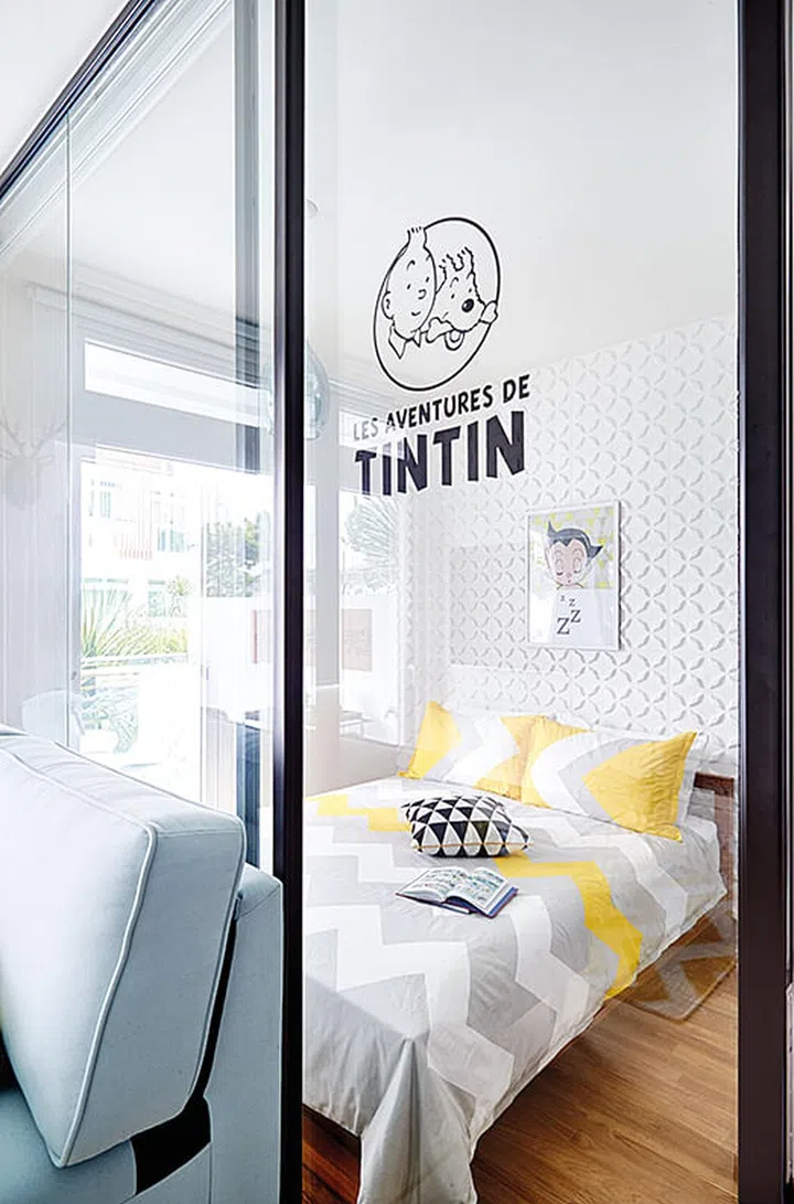 Glass panels- one of which slides to allow access into the bedroom- were installed to replace a solid wall. This allows more light into the small bedroom, and makes it appear larger.