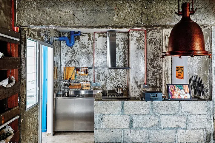 To complement the industrial look in the kitchen, the couple chose stainless steel counters.