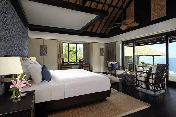 Raffles Bali’s Ocean Pool Villas are furnished in relaxing hues of wood and fabric with views of the private garden outside