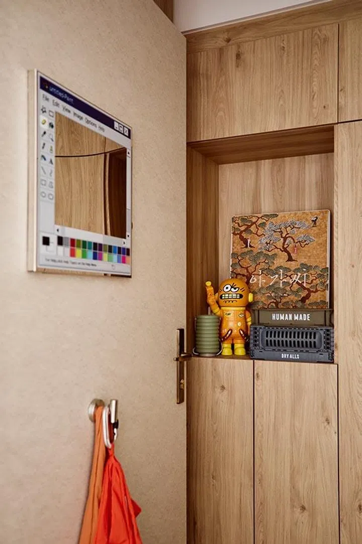 An IKEA picture-frame speaker displays a favourite film poster, blending music, memory and aspiration into one discreet entryway detail.