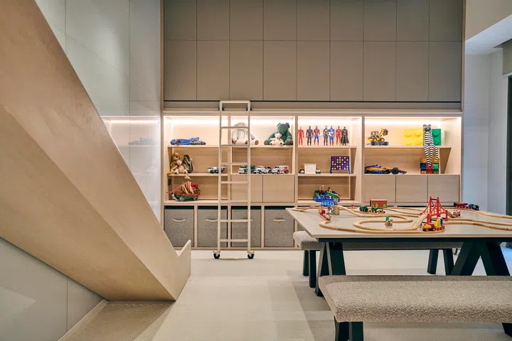 Bespoke open shelving and a movable ladder make the playroom both practical and endlessly adaptable.