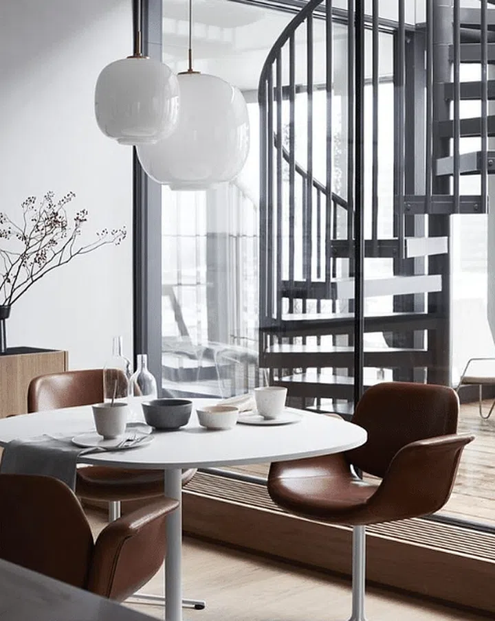 Dark modern loft style home with a white round dining table