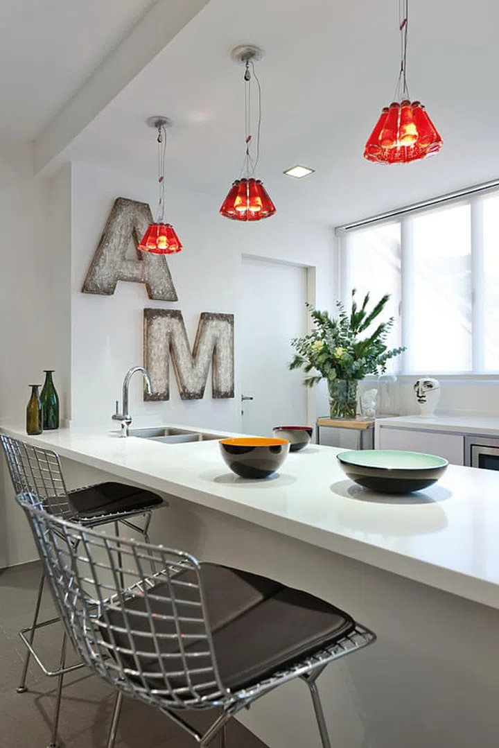 Giant block letters inspired by a vintage pharmacy shopfront and the oversized table aid in visually expanding the space.