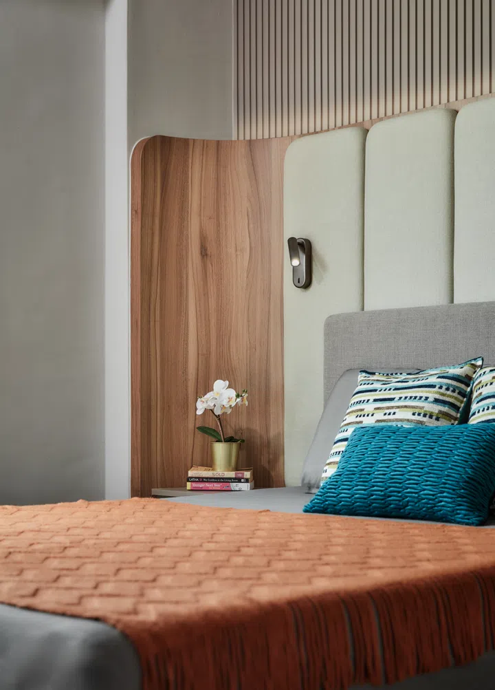 A Tempur adjustable bed is framed by a padded, curved headboard that cocoons the homeowner in comfort and style.