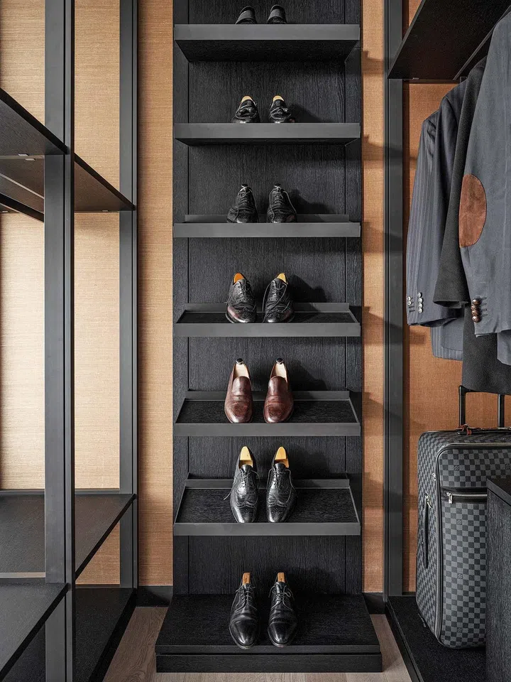 Terracotta-coloured silk wallpaper gives the wardrobe a touch of luxury.