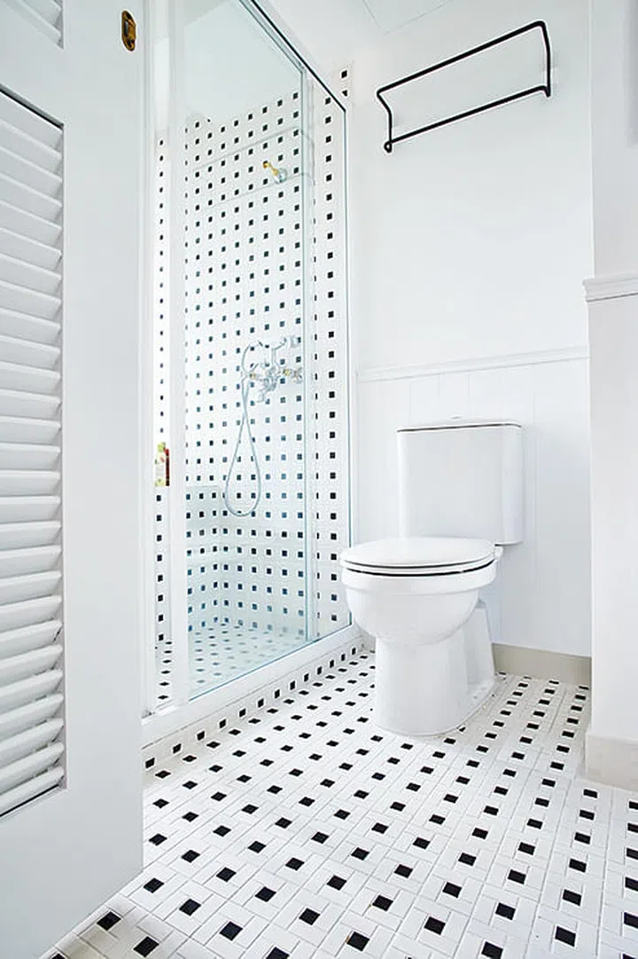 There was a need to balance all the prettiness with a “masculine” black and white palette in the master bathroom.