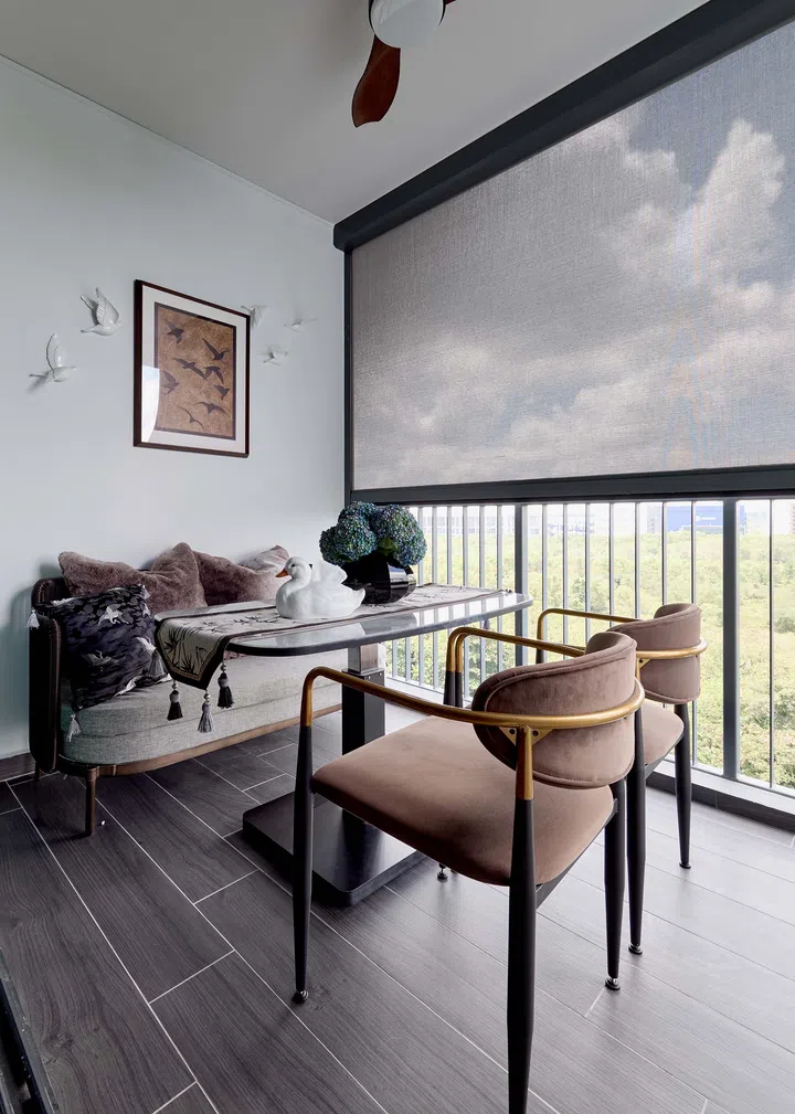 The balcony doubles as a dining area, blending indoor and outdoor spaces with versatile, weatherproof furniture.