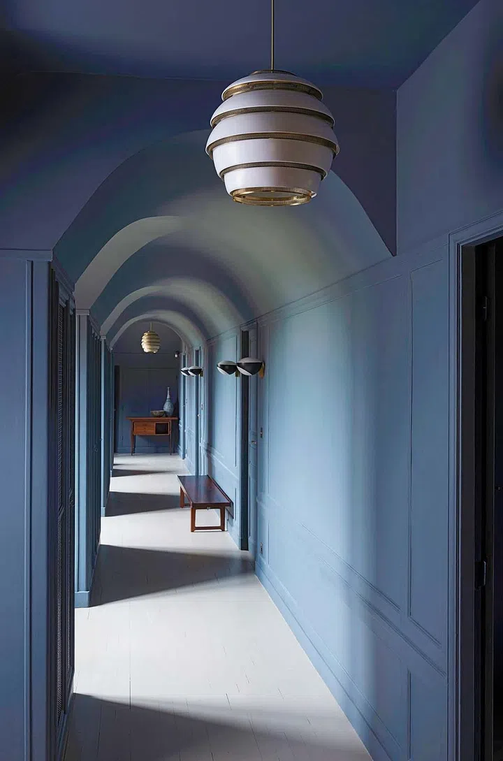 Ruche hanging light fixture by Alvar Aalto; sconces by Max Ingrand for FontanaArte; Krobo bench in rosewood by Torbjorn Afdal.