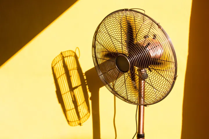 Vintage fan and its shadow from sunlight through the window.