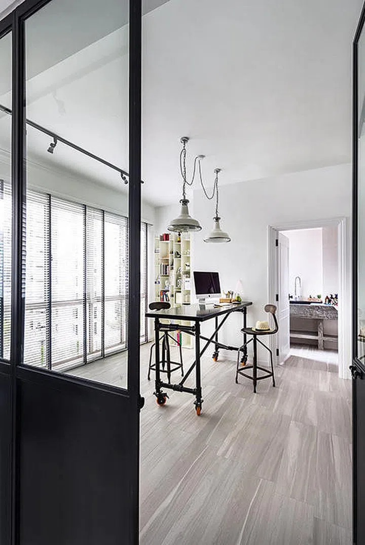 Industrial-style elements in a home office study room in an Eclectic Modern Classical 3-room condominium in Singapore.
