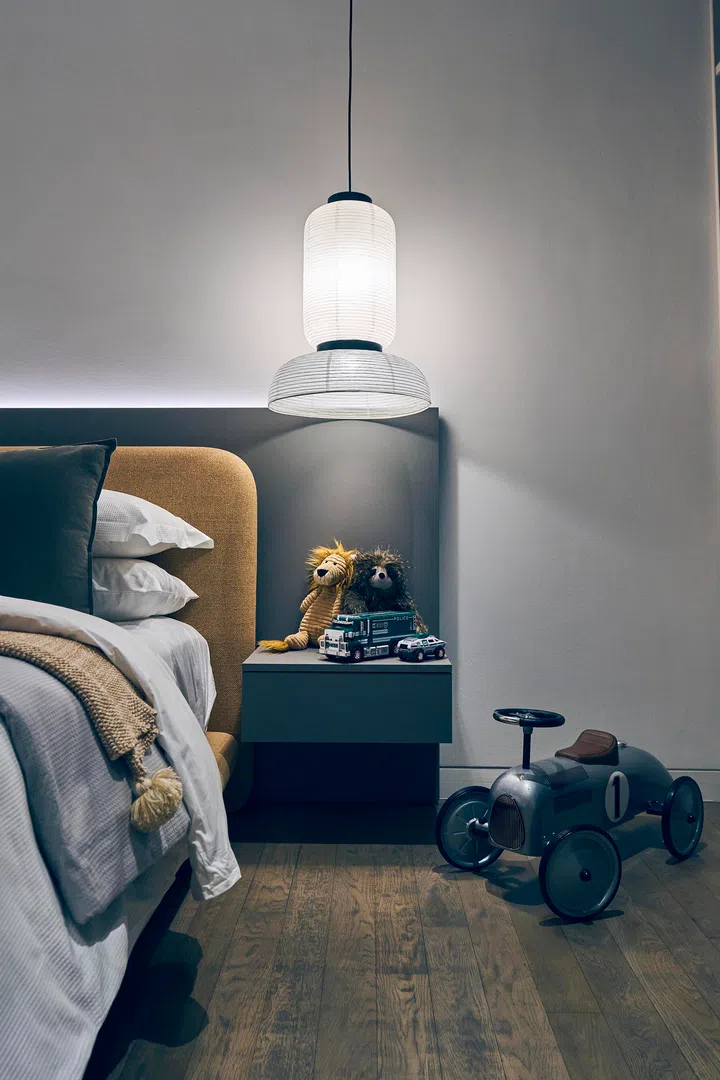 Bedside details show how playful elements are layered with comfort, creating a room that grows with its occupant.