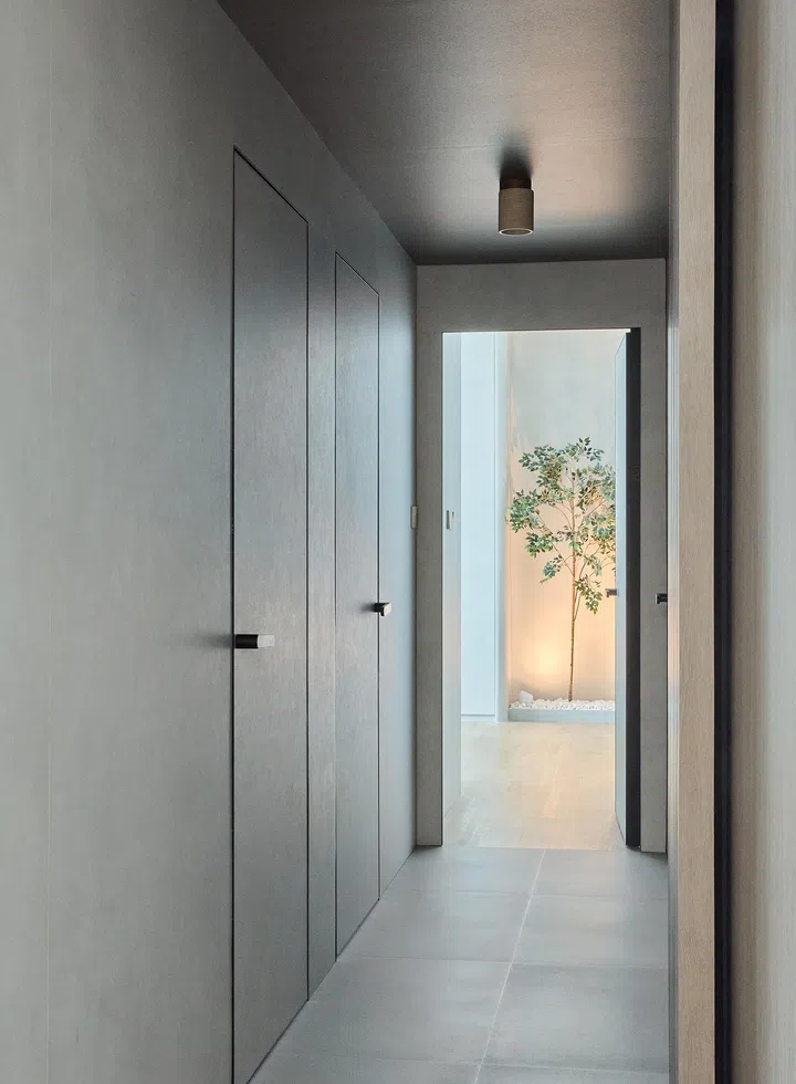 A view of the storage space alongside the artificial tree, offering both practical storage and artistic flair in the home’s design.