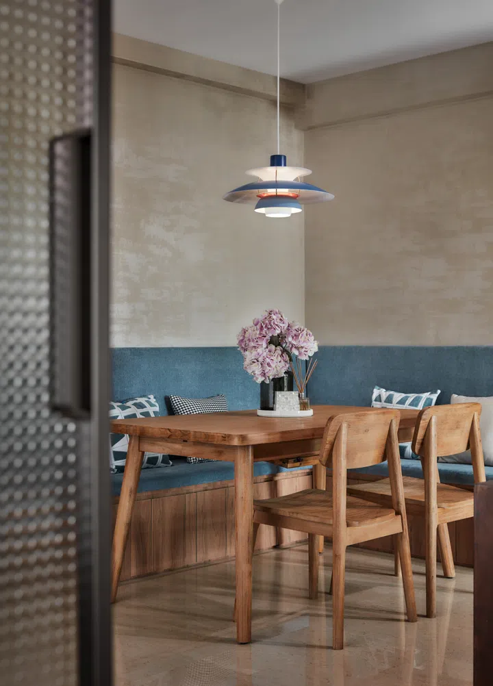 An intimate dining space centred on a wood table and pendant light, perfect for family meals and cosy gatherings.