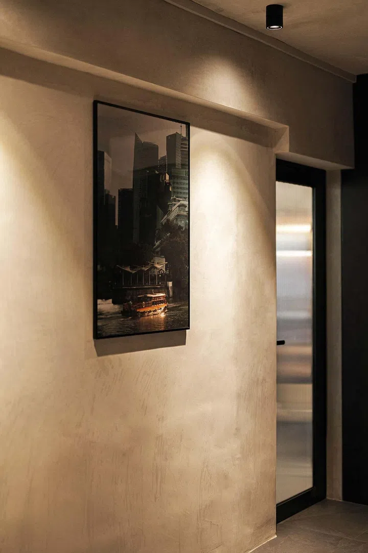 Dark grey tiles and cement-screed walls in line with the industrial theme in a 3-room HDB flat in Ang Mo Kio.