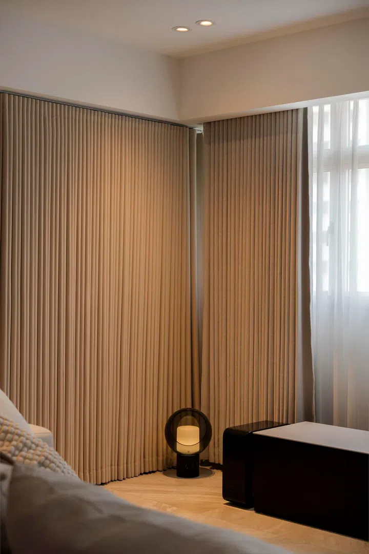 Floor-to-ceiling curtains frame the space, with functional gadgets tucked neatly into corners.