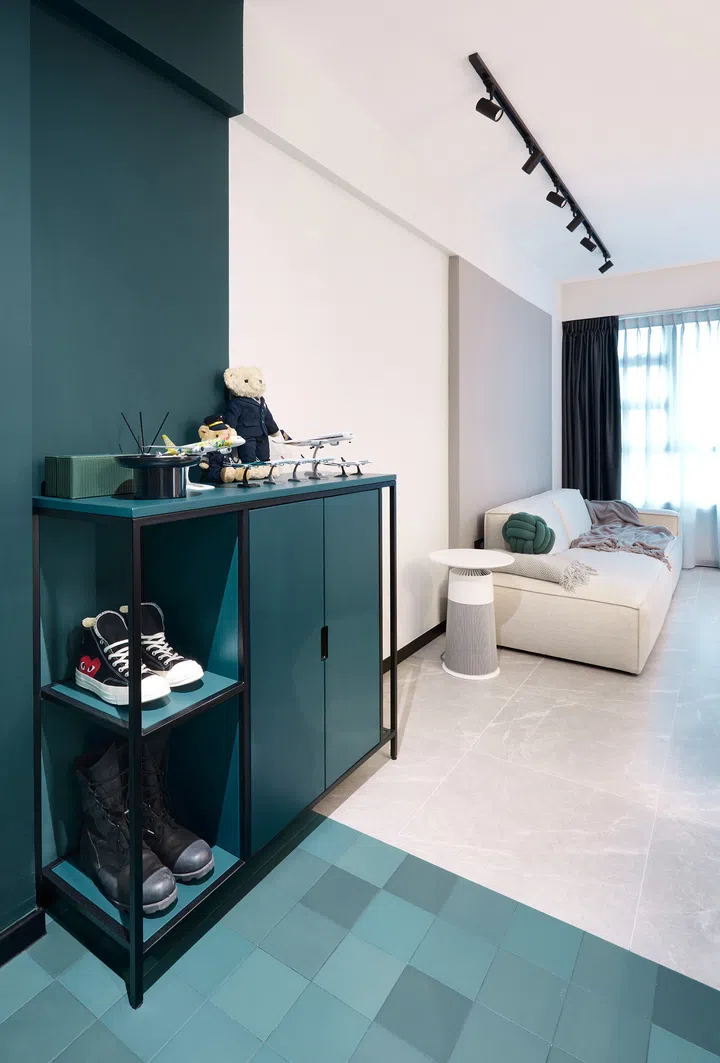 A striking green entrance foyer with pixel-patterned floor tiles and custom cabinetry.