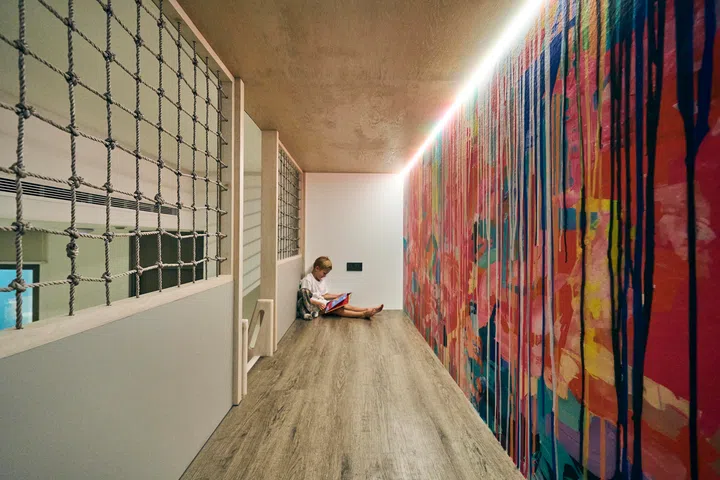 A graffiti wall and mezzanine nook turn the basement into a colourful adventure zone.