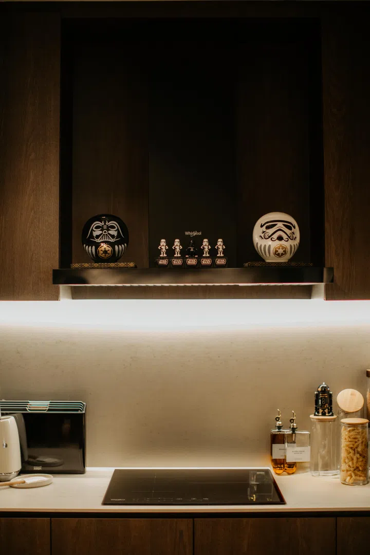 Displays are recessed into the carpentry, giving the collection presence without overwhelming the room.