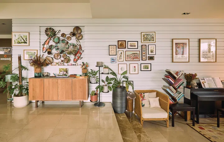 A travel wall of memorabilia ranging from Yayoi Kusama exhibition posters to works by street artists and flea market finds.