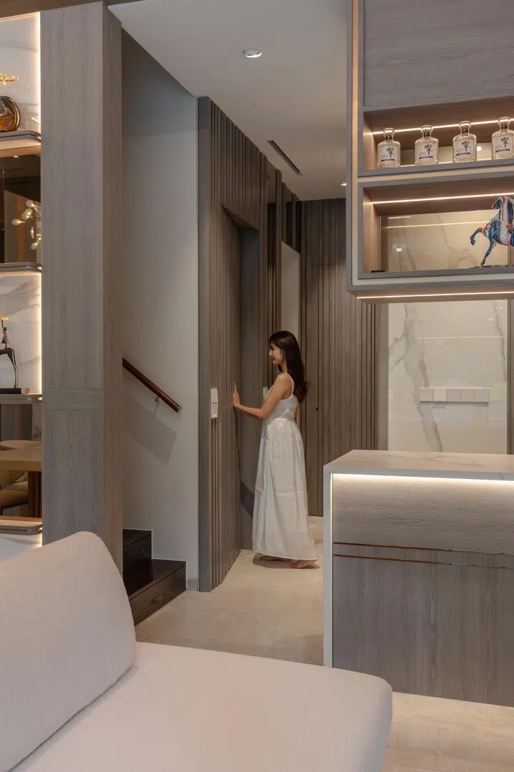 Concealed doors and continuous wall panelling keep the circulation spaces visually calm, extending the home’s elegant design language beyond the main entertaining areas.