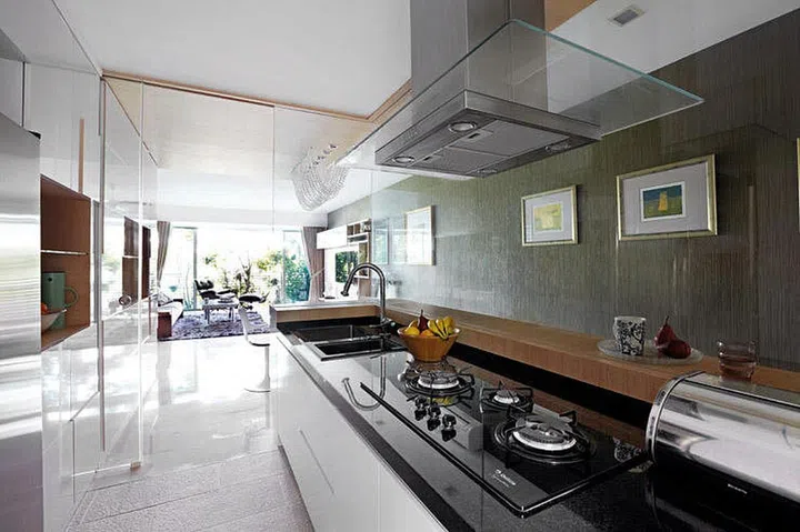 Open kitchens are visually enticing. But if you cook frequently, a practical option would be to opt for glass walls instead. With this, you can contain the smoke and have the feel of an open kitchen at the same time! (Interior design by Substance Living)