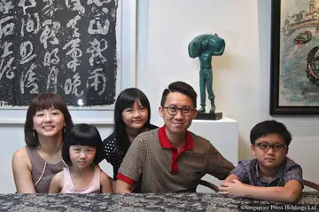 Mr Jeff Cheong, the vice-president of Tribal Worldwide Asia, with (from left) his wife Faith and their children Janneth, four, Beth, seven, and Seth, nine, in their terrace house in Telok Kurau. 