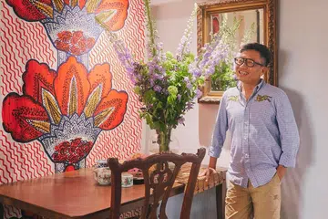 A vibrant Marimekko textile forms the backdrop to the dining area, reflecting Ivan’s willingness to mix bold contemporary pieces with traditional furnishings and collected antiques.